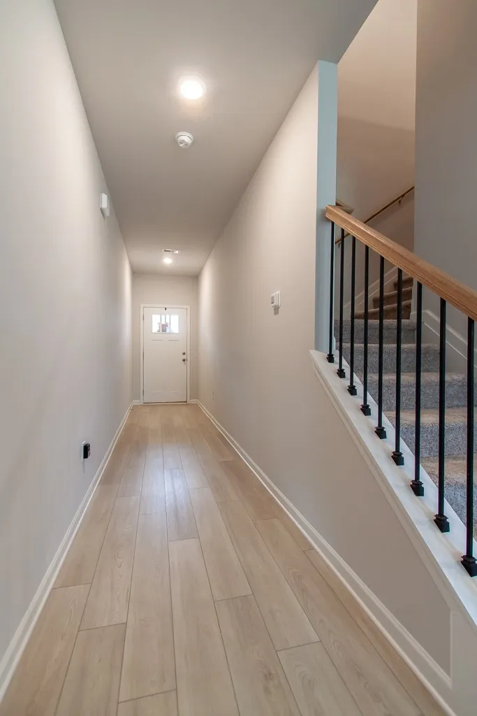 This entry hall features durable flooring, leading to a functional stairway.