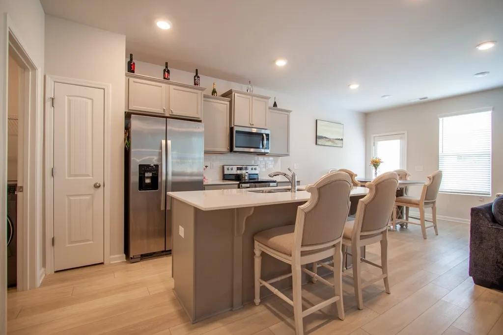 This bright kitchen features an inviting island, creating a welcoming and functional heart for daily living.