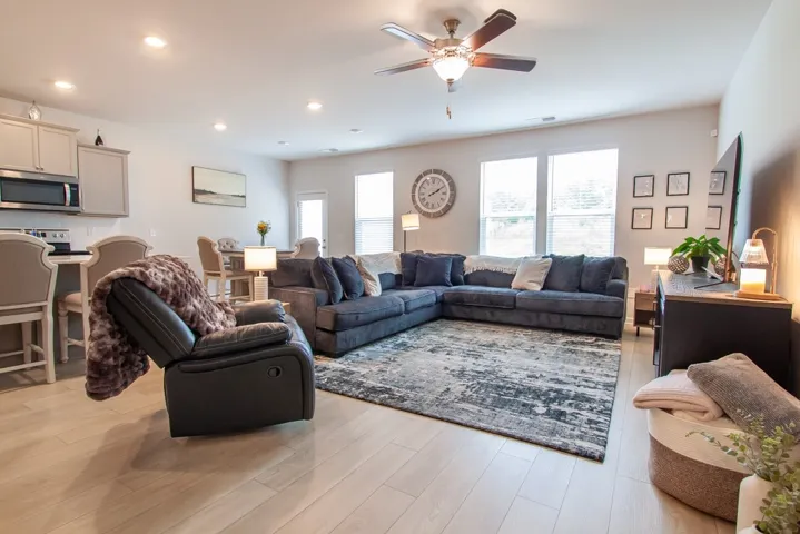 This bright and airy open-concept living area offers comfortable gathering space.