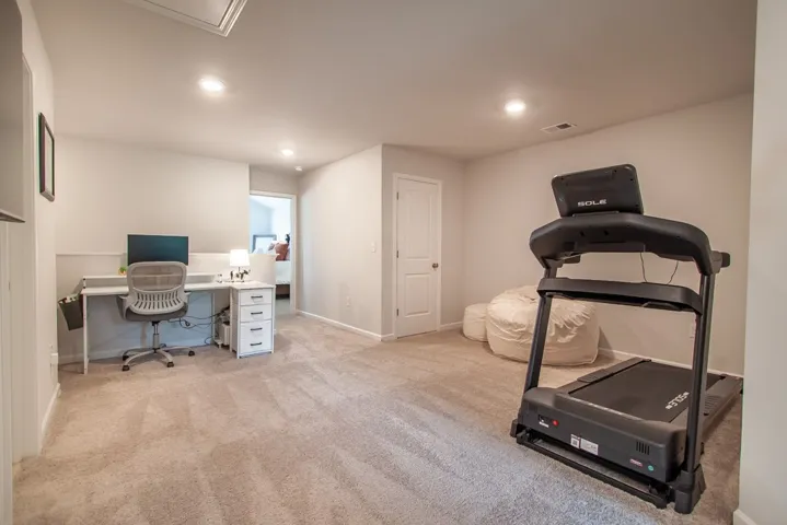 This versatile bonus room features soft carpeting, perfect for a home office or exercise area.