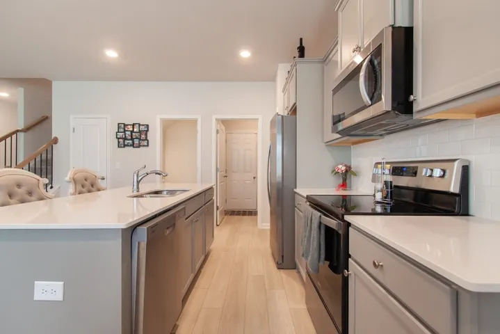 This bright kitchen features sleek appliances and a spacious island for effortless entertaining.