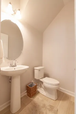 This clean and bright bathroom features contemporary fixtures and durable flooring.