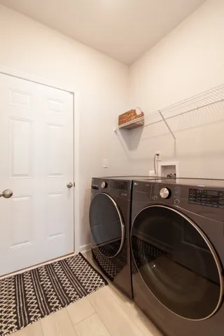 This dedicated laundry room offers convenient appliances and practical storage solutions.
