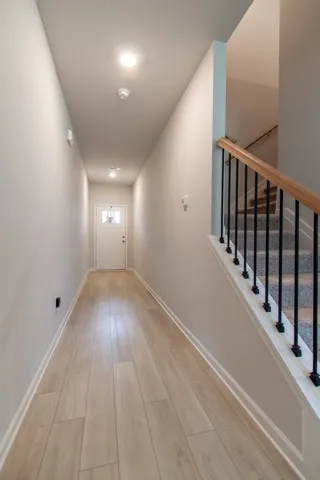 This entry hall features durable flooring, leading to a functional stairway.