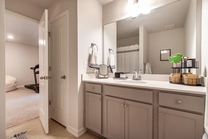 This bright bathroom features a spacious vanity with ample storage.