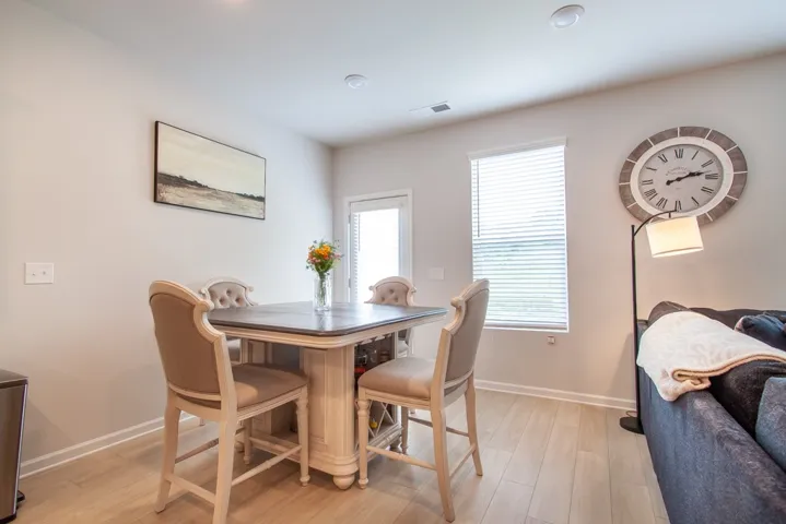 This bright dining area features an elegant table, creating a perfect space for intimate gatherings.