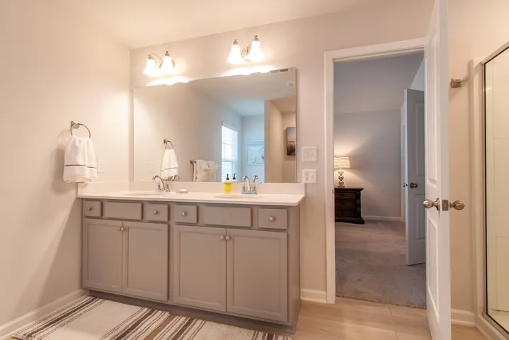 This bathroom features a double vanity and dual sinks, providing ample space for daily routines.