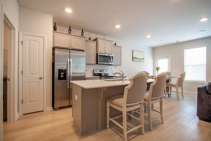 This bright kitchen features an inviting island, creating a welcoming and functional heart for daily living.