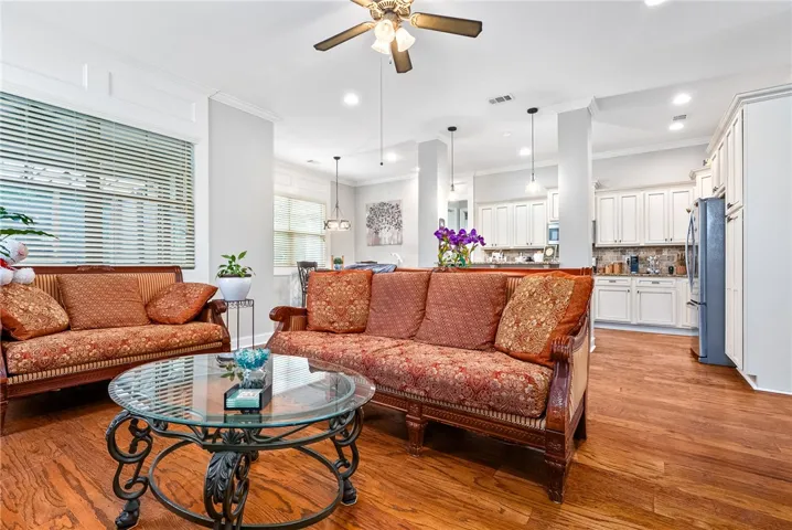 This inviting space features elegant hardwood flooring, an open layout, and a well-appointed kitchen.