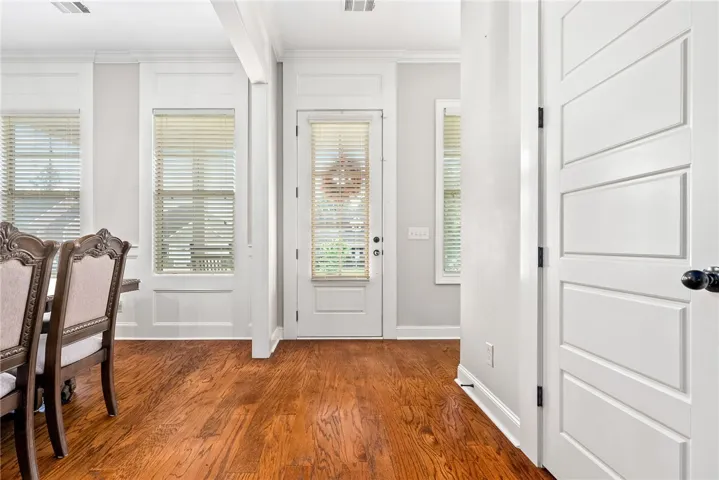 Elegant hardwood flooring enhances this welcoming entry space.