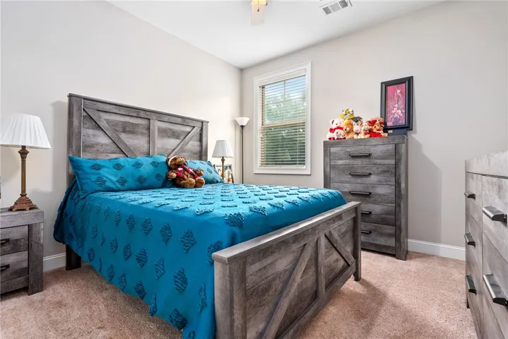 This serene bedroom offers a comfortable retreat with ample natural light.