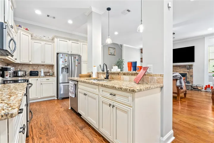 This spacious kitchen features ample cabinet space, modern appliances, and beautiful countertops, ideal for daily living.