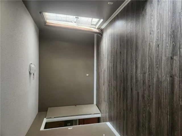 This interior hallway features a distinctive flooring, perfect for a modern aesthetic.