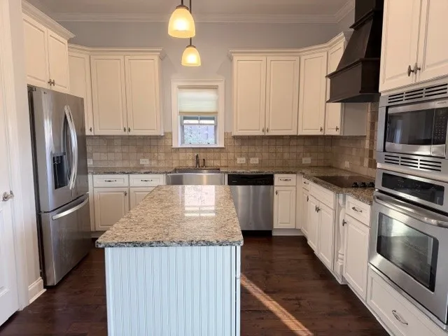 This chef's kitchen features stainless steel appliances and abundant counter space.