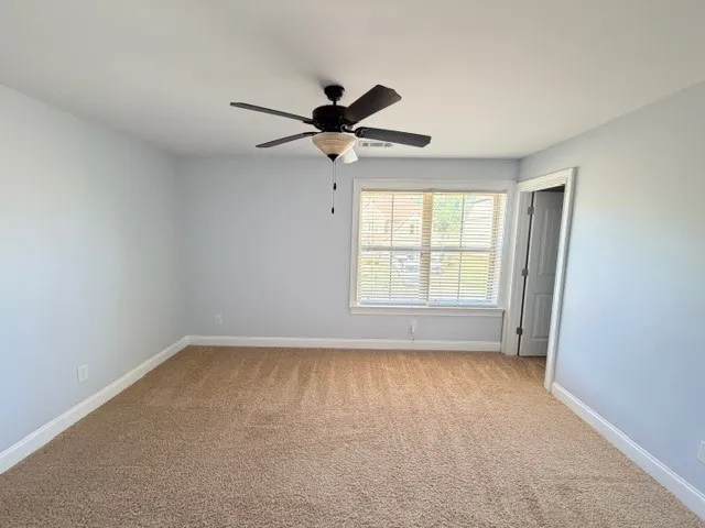 This airy room features a large window, offering abundant natural light and a pleasant ambiance.