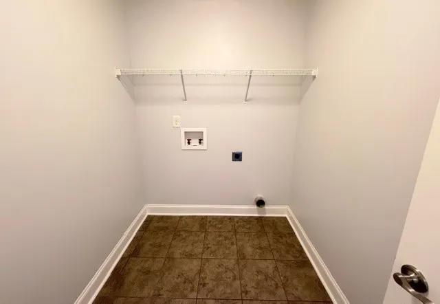 Functional utility room with ample space and easy-care tiled flooring.