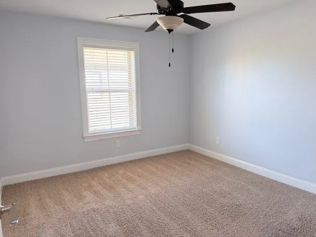 This cozy room offers a bright window and soft carpet, ideal for peaceful living.