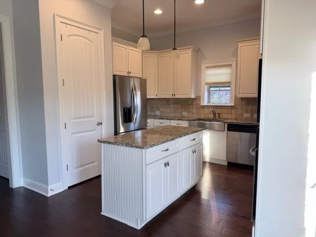 This bright kitchen features sleek appliances and ample counter space.