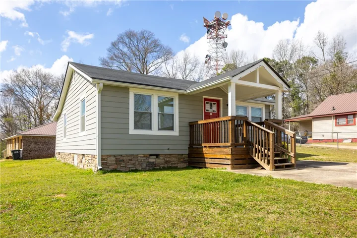 This charming home offers a welcoming facade with a covered porch and an inviting entrance.