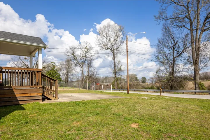 This property features a charming wooden deck, offering an inviting outdoor space for relaxation.
