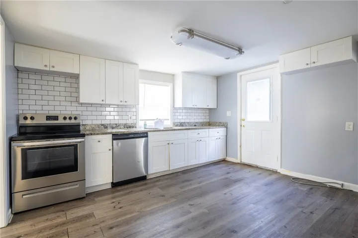 This newly renovated kitchen features sleek stainless steel appliances and ample counter space, perfect for culinary adventures.
