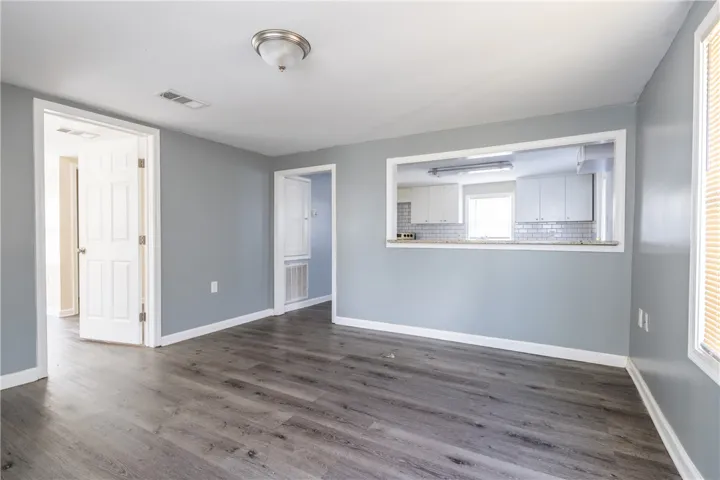 This airy interior space features a pass-through to the kitchen and durable flooring.