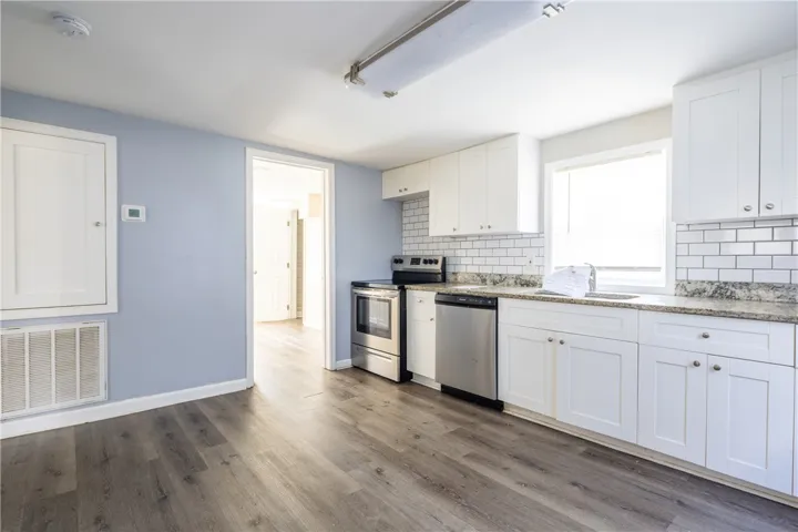 This newly updated kitchen offers ample space for culinary creations and casual dining.