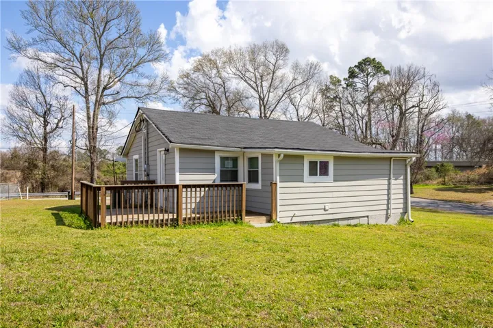 This cozy home offers a charming exterior with a spacious yard, perfect for outdoor enjoyment.