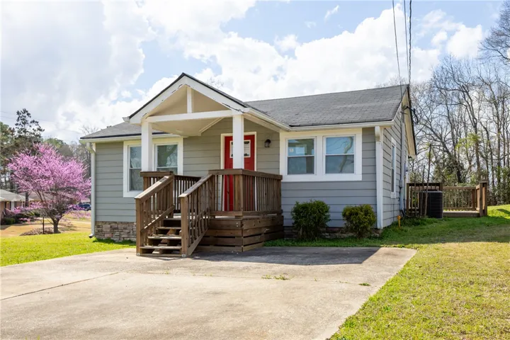 This charming residence features a welcoming front porch and a well-maintained exterior.