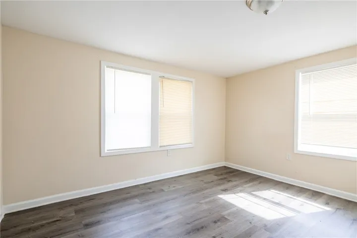 This bright room features durable flooring and ample natural light, creating an inviting atmosphere for any purpose.