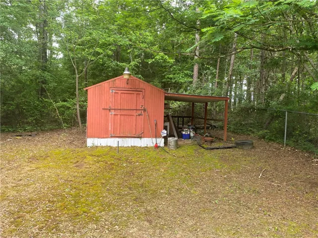 This versatile shed and covered area offer abundant outdoor storage and utility.