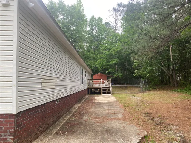 This charming home offers a spacious yard with a deck and fenced area, perfect for outdoor enjoyment.