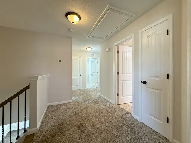 A well-lit landing area connects various rooms within this inviting home.