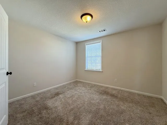 This spacious room offers comfort and potential for personalized design.