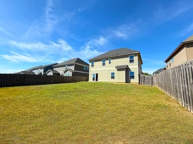This expansive yard offers ample space for outdoor enjoyment and potential landscaping projects.