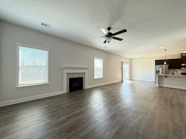 This expansive living area seamlessly connects to the kitchen, creating an inviting open floorplan.