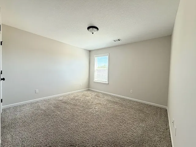 This spacious room offers comfort and potential, ready for personalization.