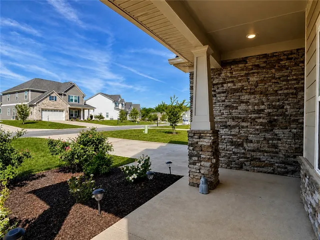 This inviting porch offers a warm welcome to a lovely neighborhood home.