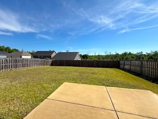 An inviting private yard with a patio offers a peaceful outdoor retreat.