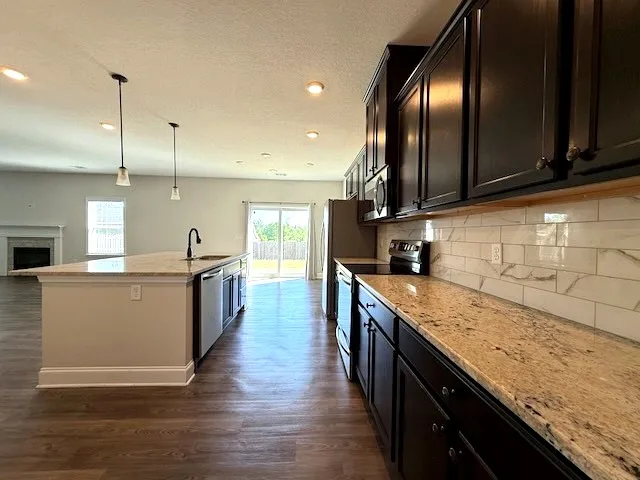 This open concept kitchen offers abundant counter space and easy access to outdoor living.