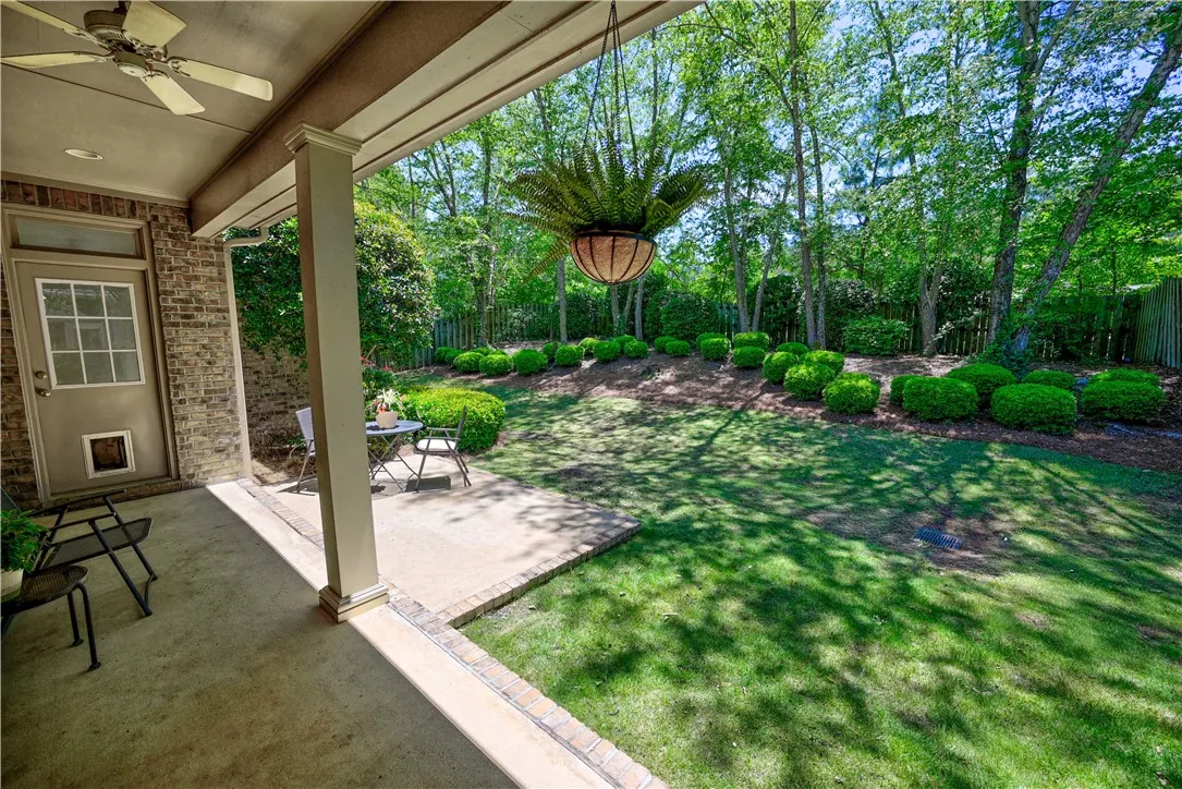 Covered porch overlooks a private, fully fenced backyard, perfect for outdoor enjoyment.