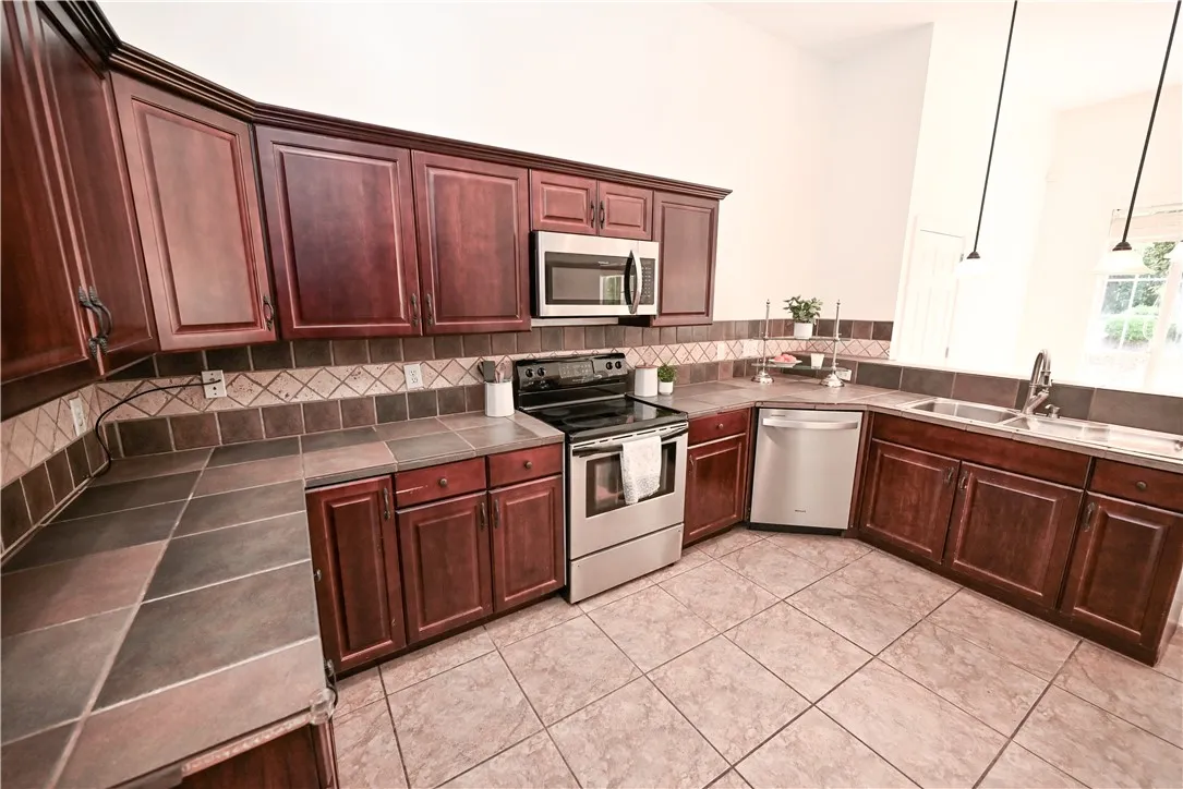 Spacious kitchen with ample storage and modern stainless steel appliances.