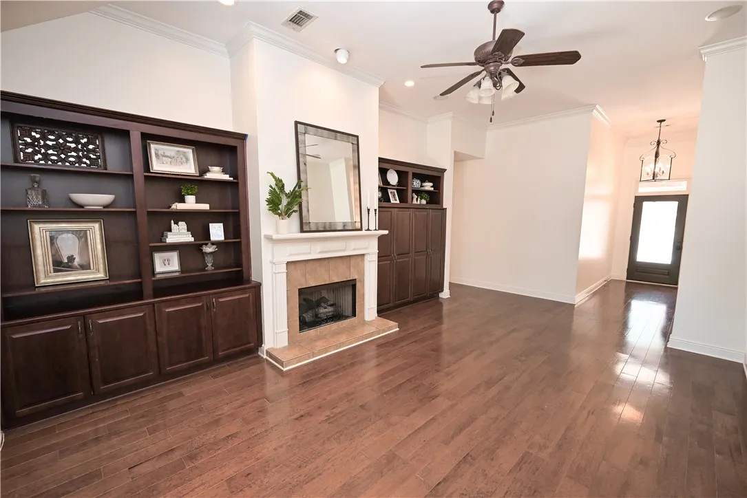 Cozy gas fireplace flanked by beautiful custom built-ins.