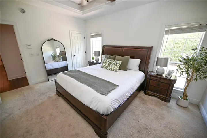 Primary features tray ceiling and large windows.