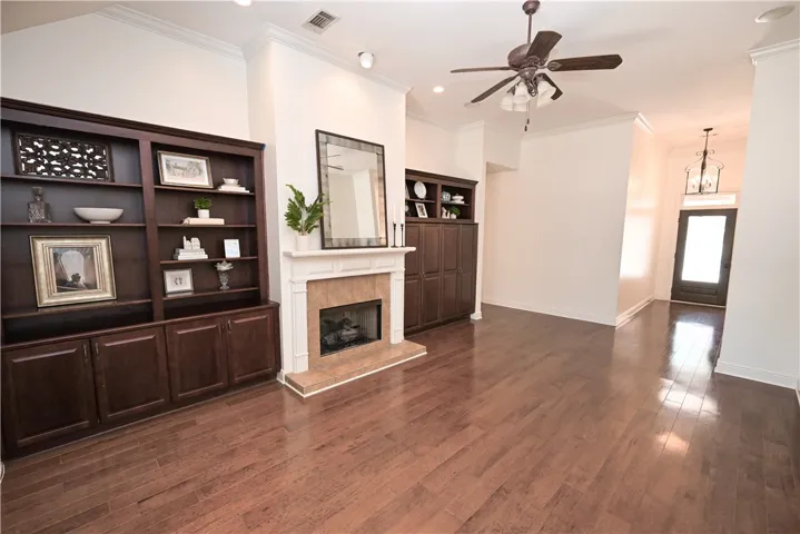 Cozy gas fireplace flanked by beautiful custom built-ins.
