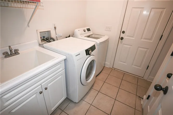 Laundry room includes sink and storage.
