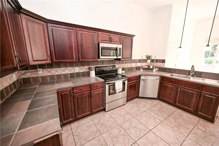 Spacious kitchen with ample storage and modern stainless steel appliances.