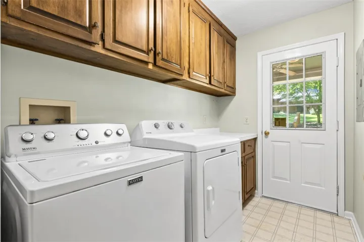 laundry with storage doubles as mudroom with its exterior door