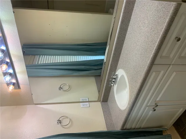 This bathroom features a sleek vanity, offering both practicality and modern appeal.