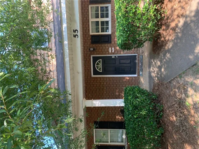 This charming residence features a classic brick exterior and a welcoming entryway.